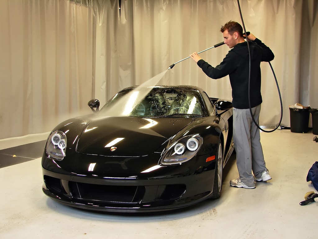 young guy cleaning a sports car