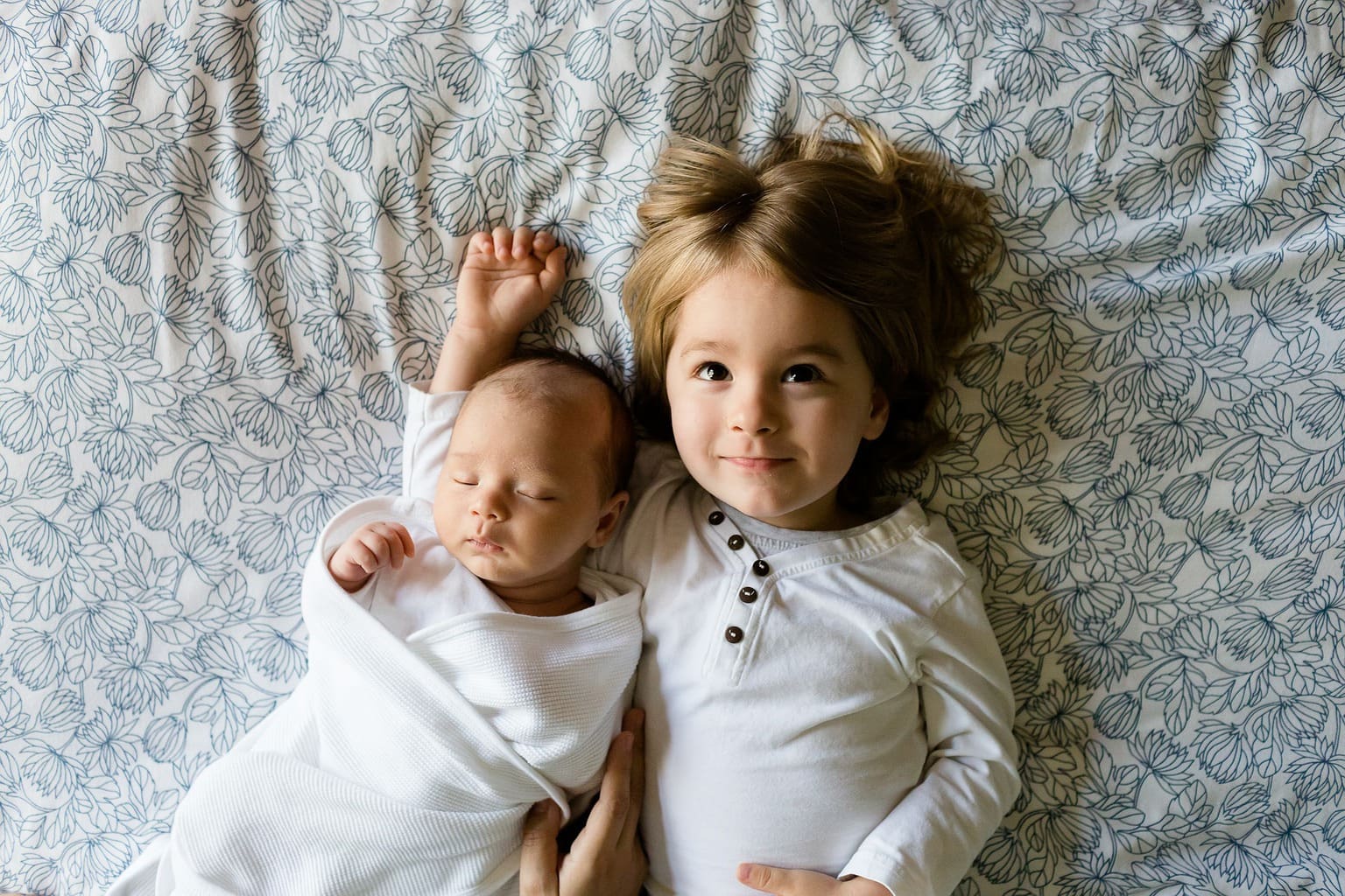 Photograph of a baby and boy siblings