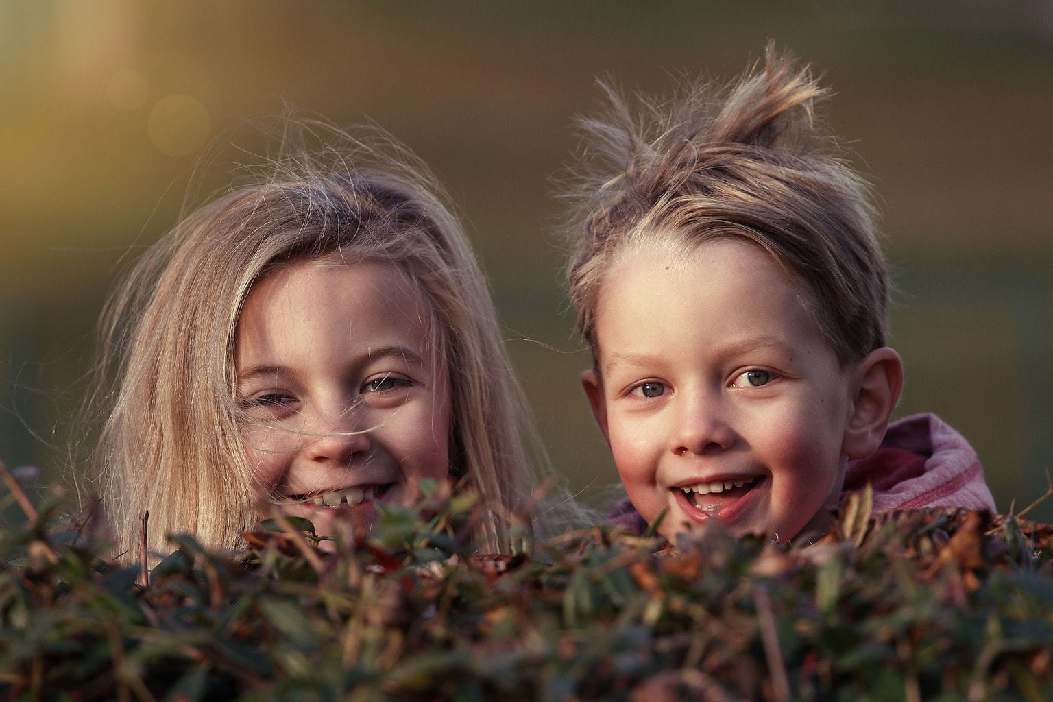 Photograph of siblings smiling at the camera