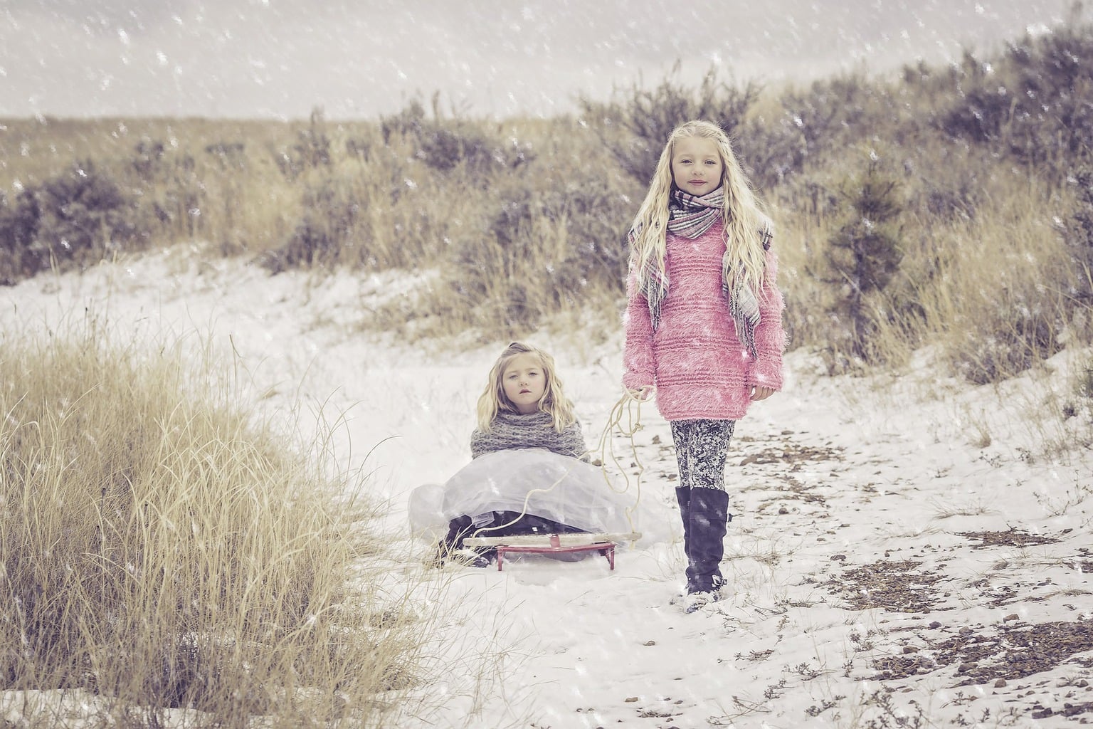 Photograph of two sisters under the snow