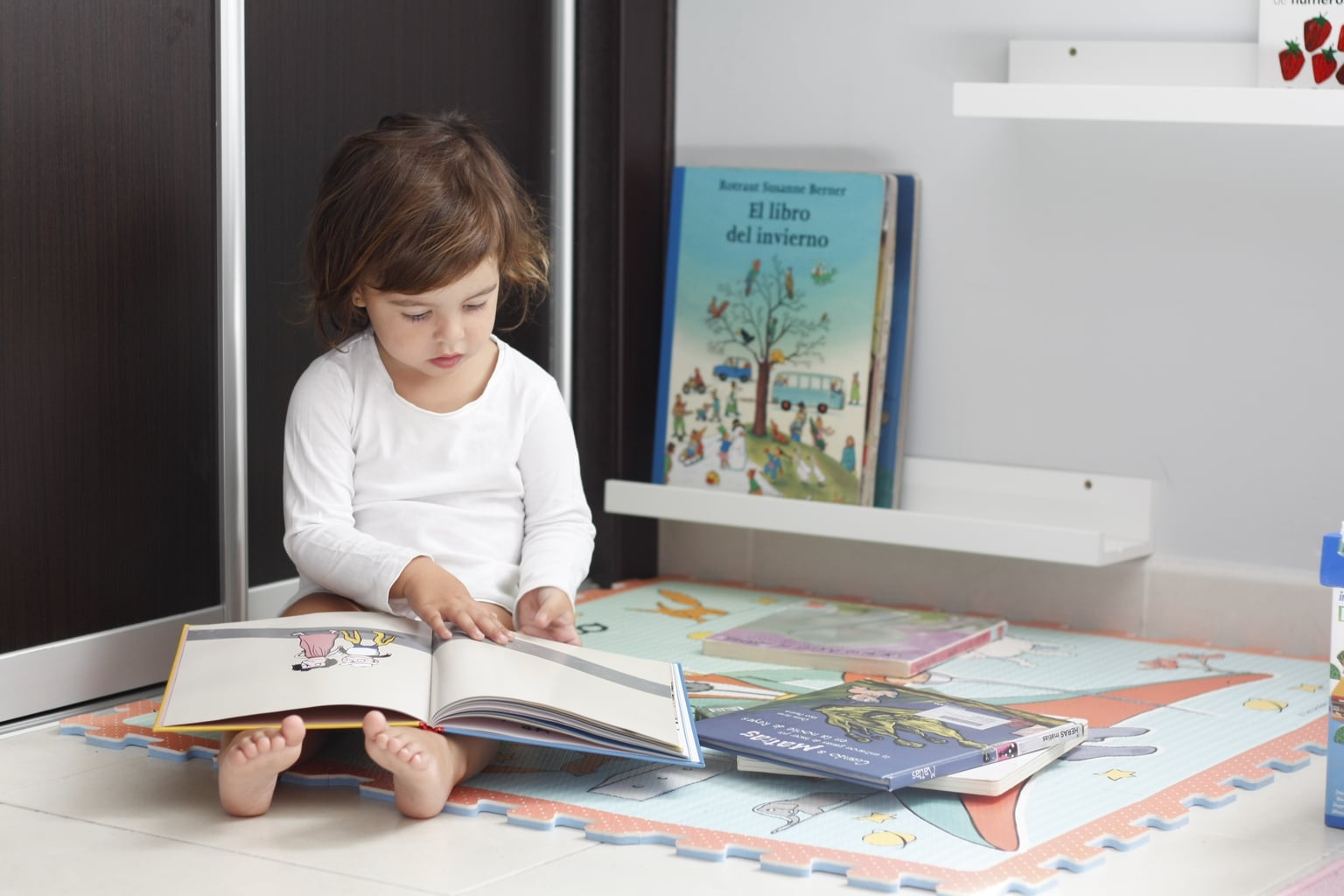 Photo of girl sitting on the floor reading stories