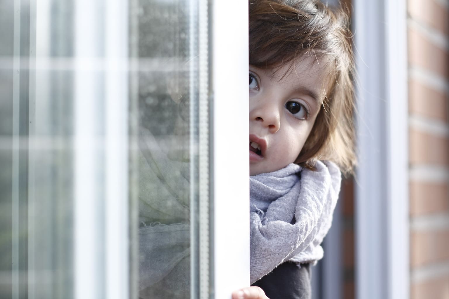 Photo of girl leaning out of a window