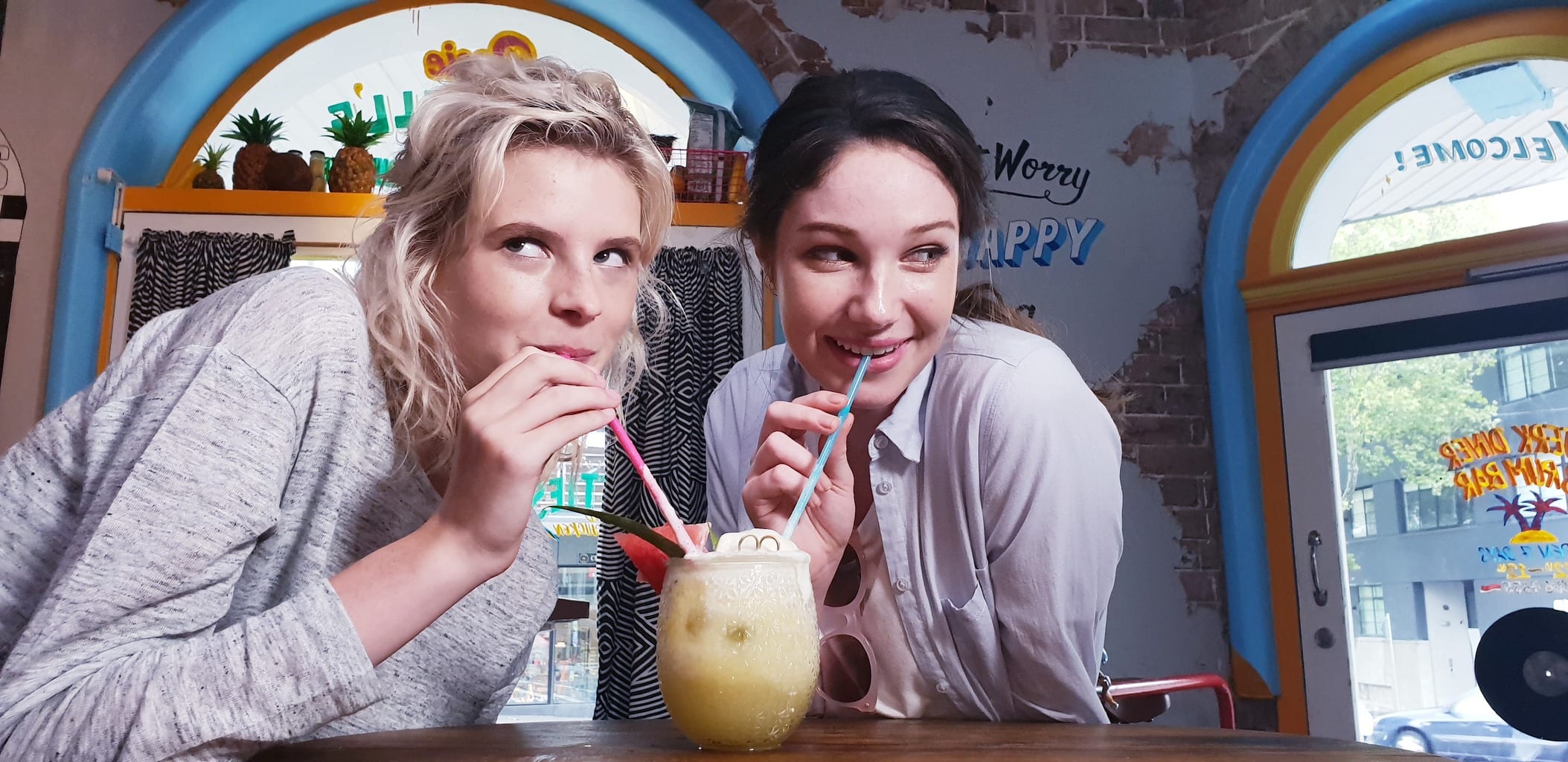 Two girls sharing drink photographed with Samsung S9