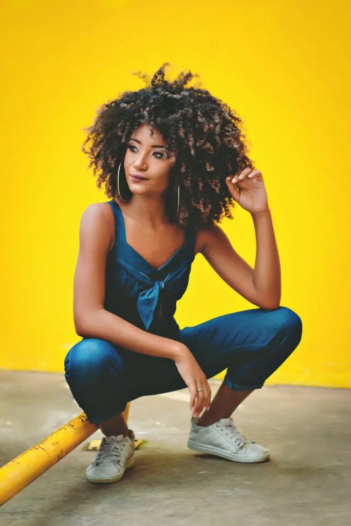 Mujer de pelo afro con fondo amarillo 