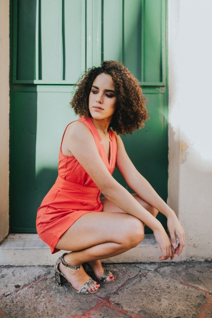 young girl posing squatting