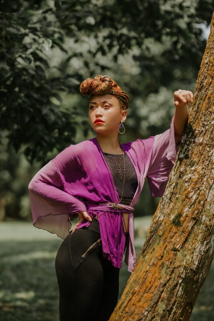 Portrait woman leaning on tree