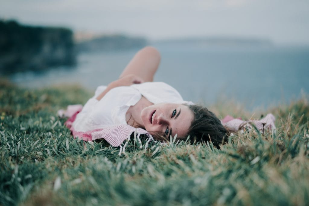 portrait of woman lying on grass