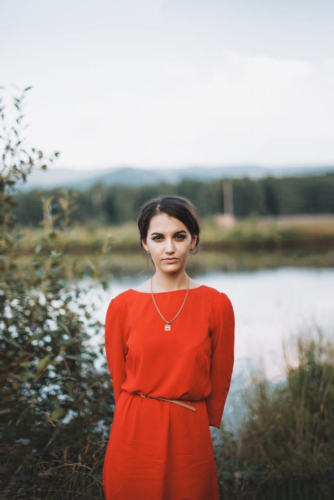 Girl posing with lake in the background