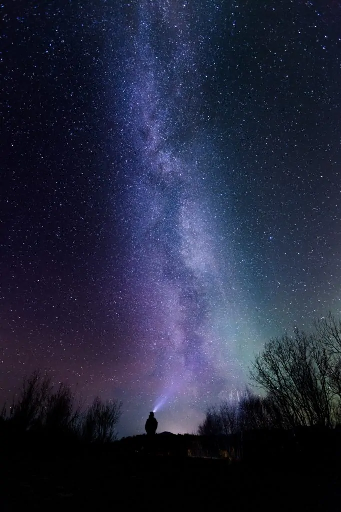 fotografía nocturna con cielo de estrellas y silueta con frontal