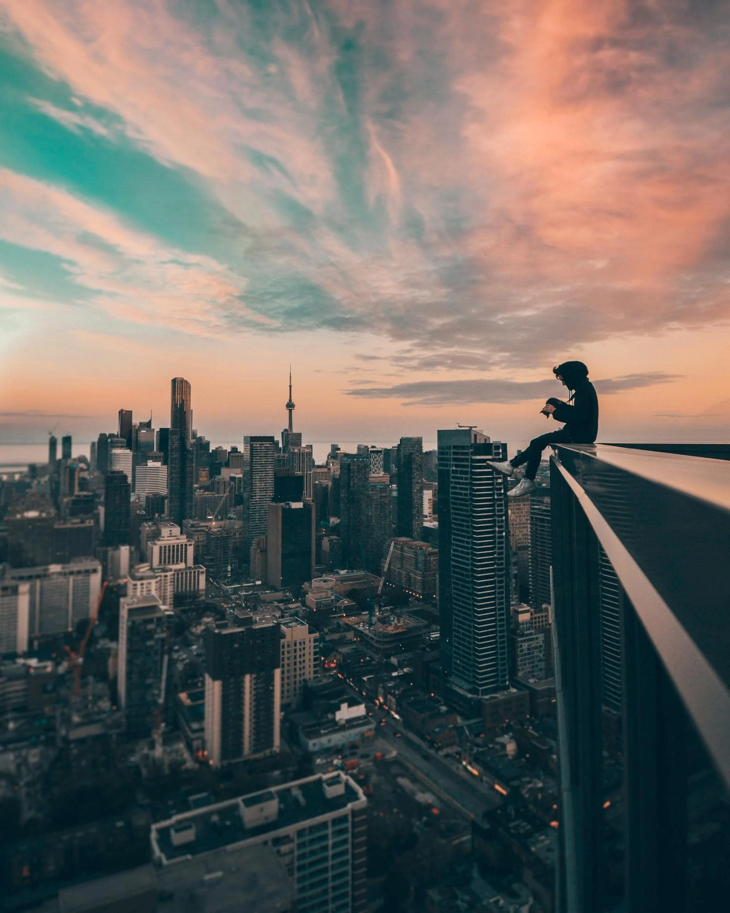 Photographer on top of a building with views of the city in the background