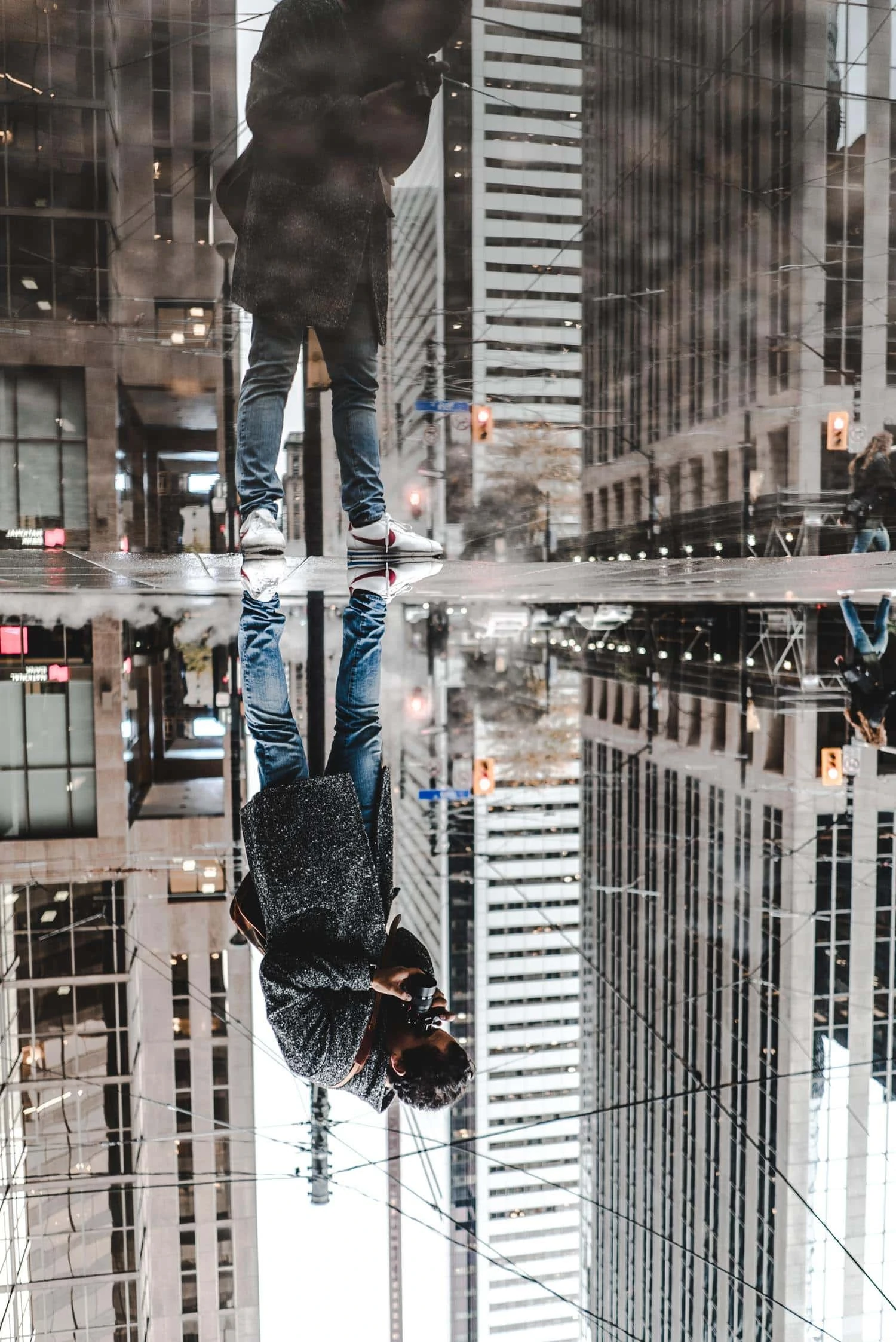 Photographer capturing a reflection in a puddle