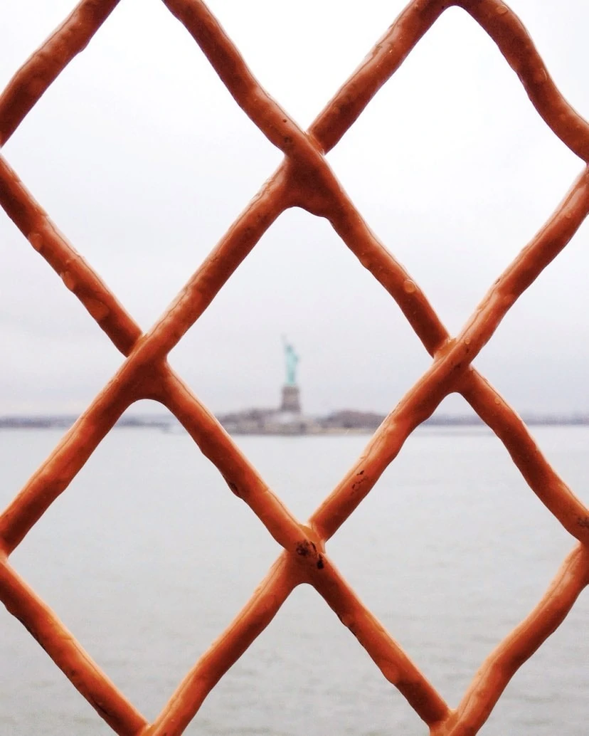 statue liberty through fence