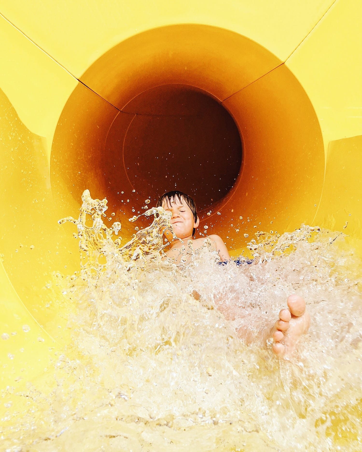 Child in water photographed with mobile