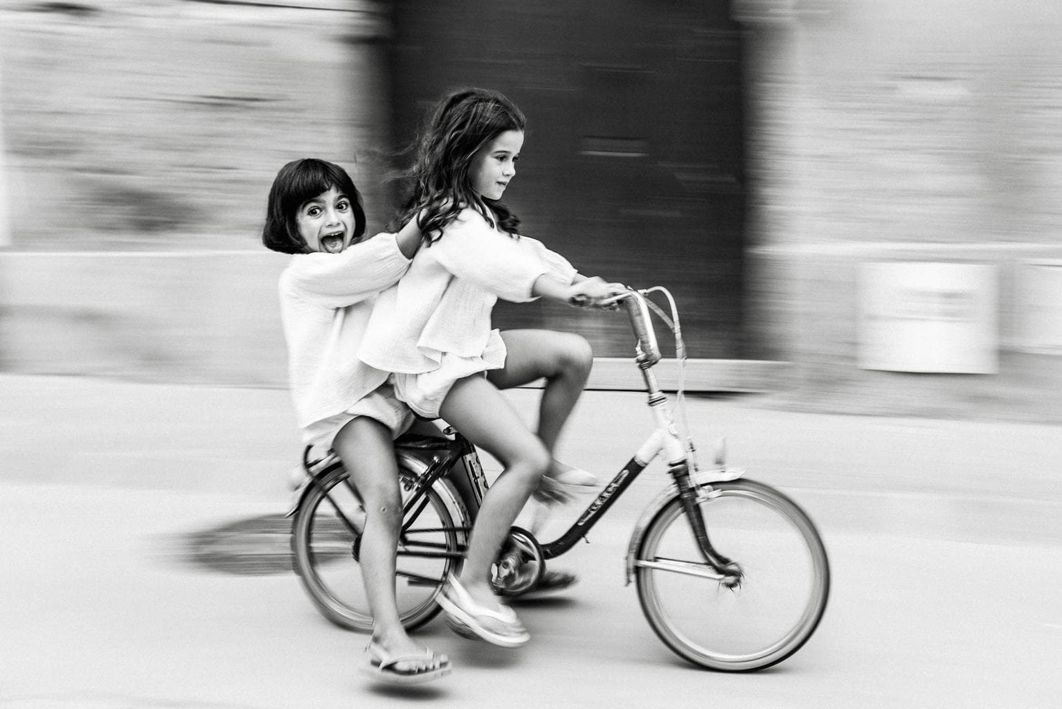 Girls on bikes at full speed with panning effect