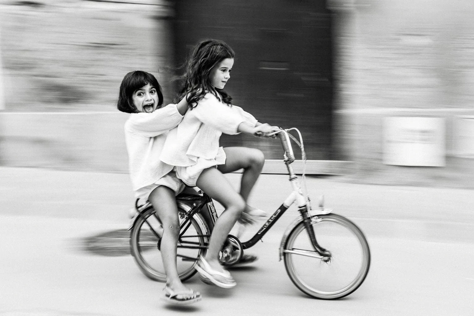 Niñas en bicicleta a toda velocidad con efecto panning