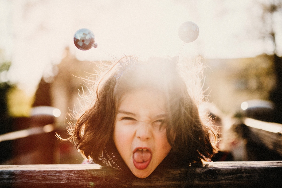 Backlit girl with funny gesture