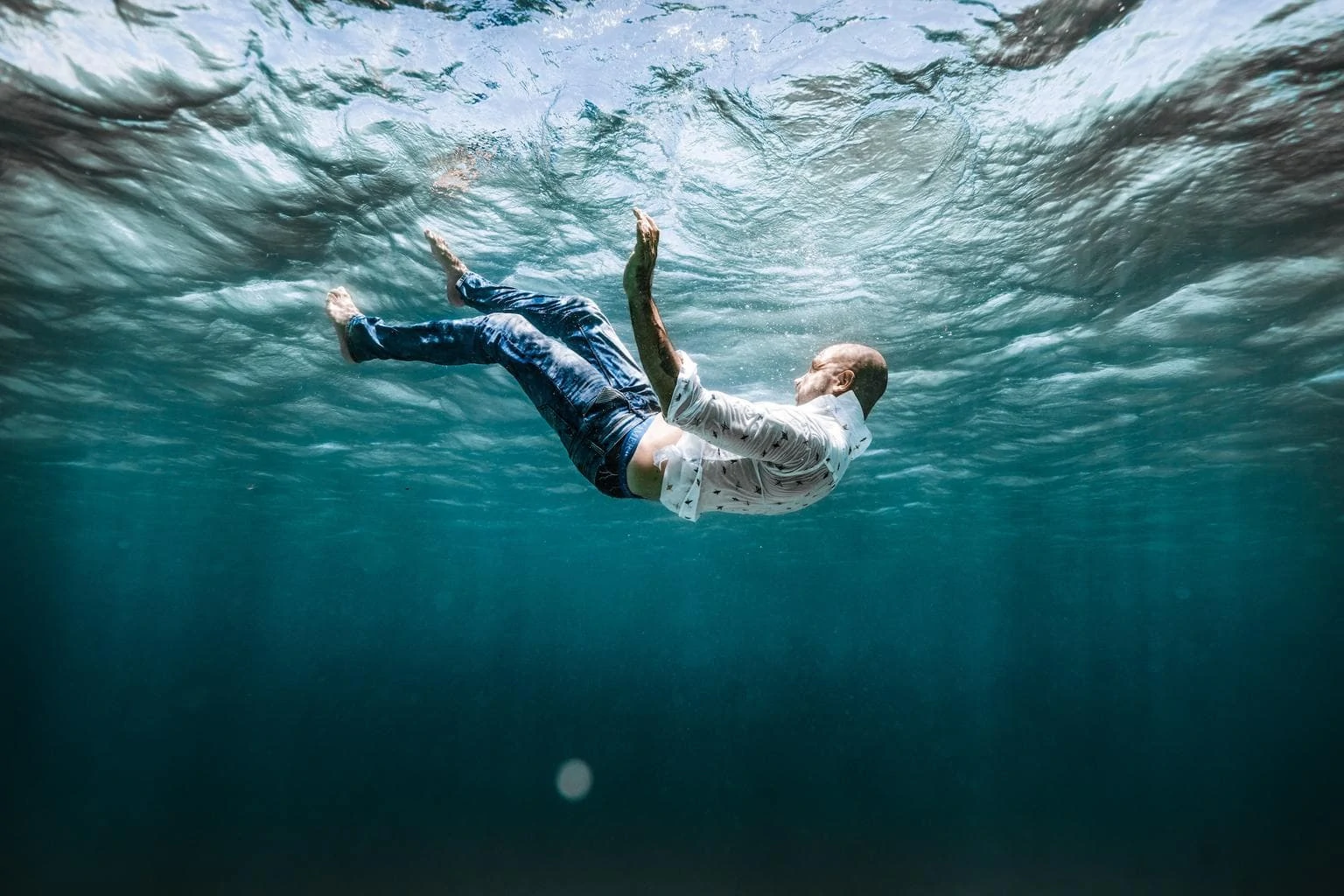 Artistic photo of man dressed under water