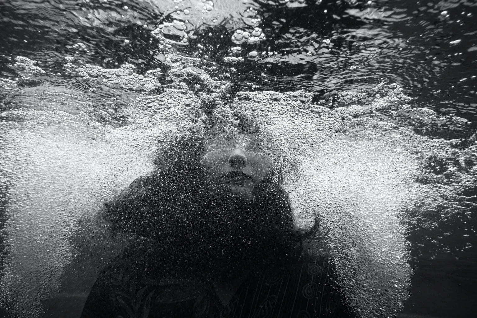 Underwater portrait of woman in black and white