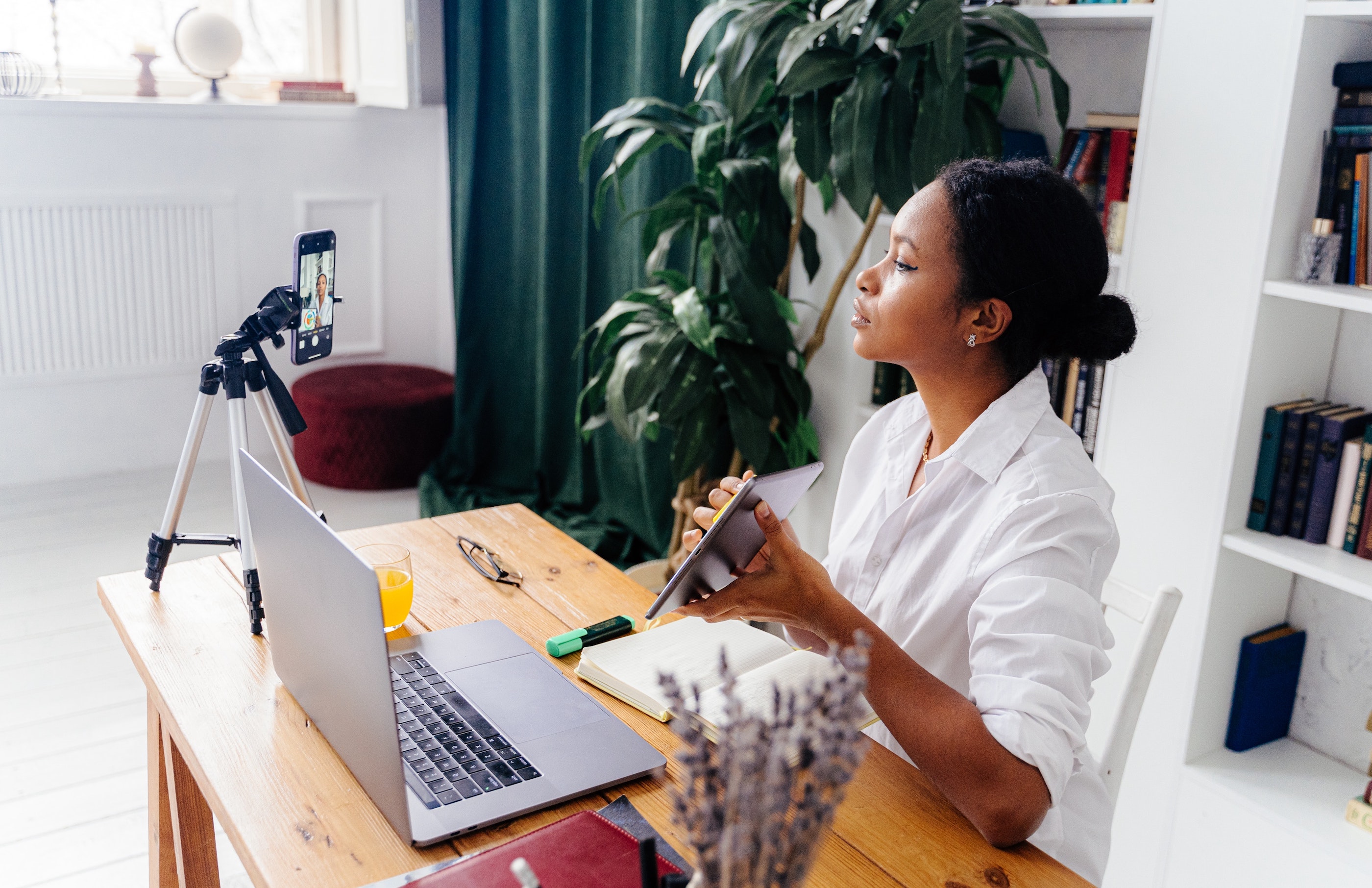 woman in meeting with mobile tall tripod