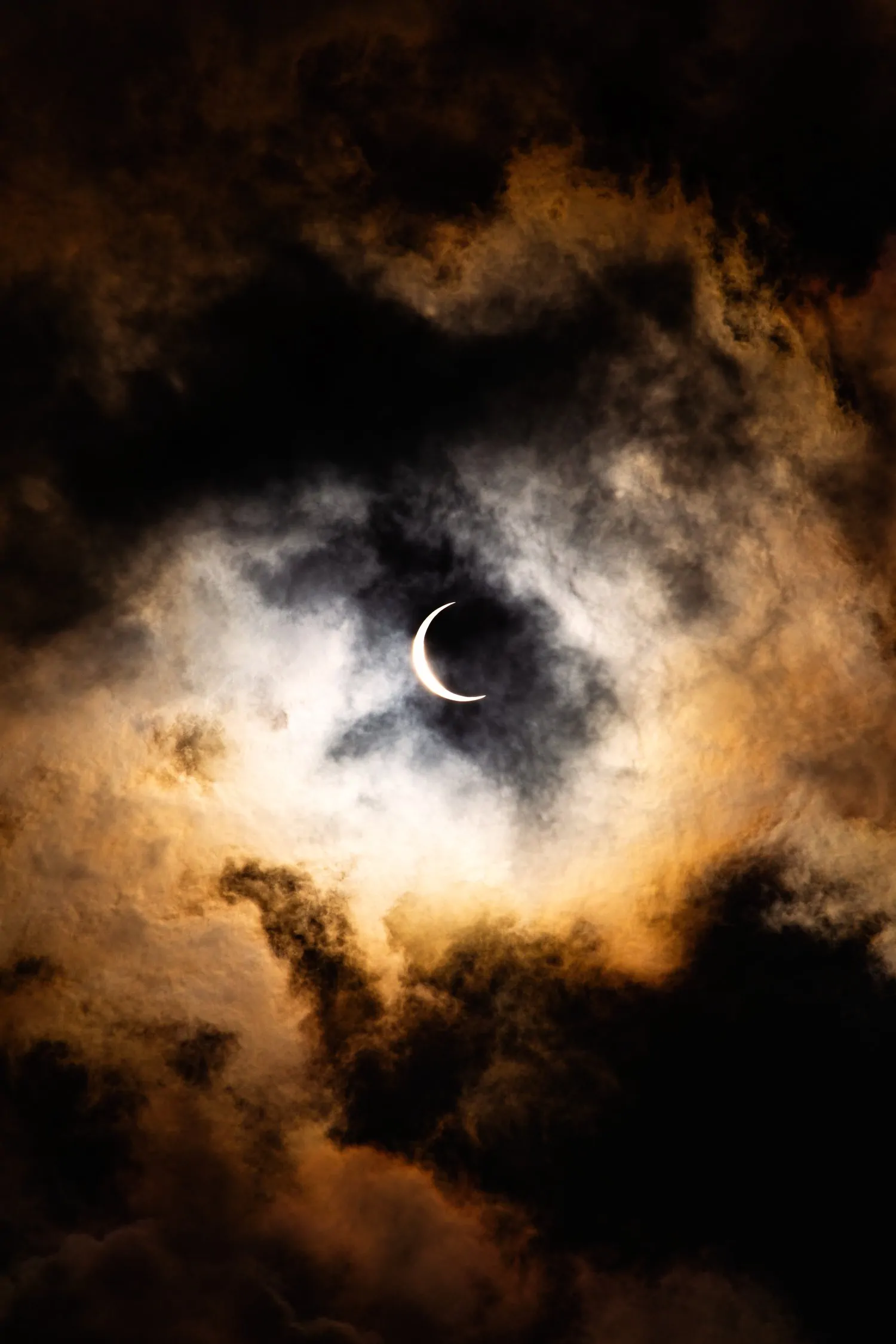 Lunar eclipse surrounded by clouds