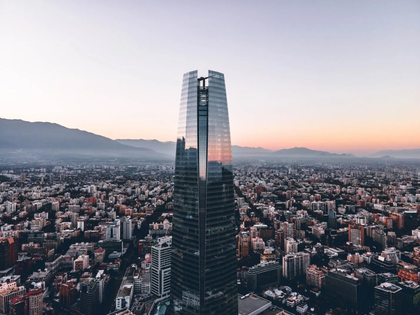 Skyscraper against a panoramic aerial view of Barrio El Golf, Santiago, Chile